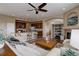 Open concept living room with a stylish blend of kitchen, fireplace, and comfortable seating at 24621 E Berry Pl, Aurora, CO 80016