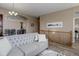 Open-concept layout featuring a staircase with wooden railing and a view into the dining area at 24621 E Berry Pl, Aurora, CO 80016