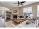 Comfortable living room with fireplace, plush seating, and lots of natural light from the windows at 24621 E Berry Pl, Aurora, CO 80016
