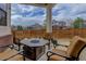 Covered patio with comfortable seating and a fire pit, perfect for outdoor entertaining at 24621 E Berry Pl, Aurora, CO 80016