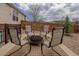 Outdoor patio area with a circular fire pit and four cushioned chairs at 24621 E Berry Pl, Aurora, CO 80016