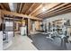 Unfinished basement with exposed beams and a potential gym and sauna at 8981 E Amherst Dr # E, Denver, CO 80231
