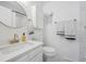 All-white bathroom featuring modern fixtures, a large mirror, and ample storage at 8981 E Amherst Dr # E, Denver, CO 80231