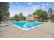 Community pool with clear blue water, chairs, shade, and a well-maintained pool house at 8981 E Amherst Dr # E, Denver, CO 80231