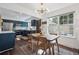 Dining area with wood table and access to kitchen featuring blue cabinets and stainless appliances at 8981 E Amherst Dr # E, Denver, CO 80231