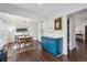 Open dining room features hardwood floors, designer light fixture, and blue accent cabinets at 8981 E Amherst Dr # E, Denver, CO 80231