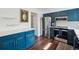 The updated kitchen features modern appliances, white countertops, and stylish blue cabinets at 8981 E Amherst Dr # E, Denver, CO 80231