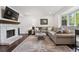 Bright living room with hardwood floors, fireplace, bay window, and stylish furnishings at 8981 E Amherst Dr # E, Denver, CO 80231