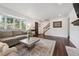 Stylish living room boasts hardwood floors, a cozy fireplace, and a large bay window at 8981 E Amherst Dr # E, Denver, CO 80231