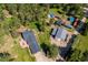 Aerial view showcasing the property's layout, including the house, barn, driveway, and surrounding lush greenery at 29263 Sue Rd, Evergreen, CO 80439
