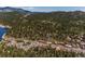 An aerial view of a town settled in a lush green forest, with rolling mountains in the background at 29263 Sue Rd, Evergreen, CO 80439