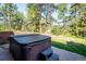 Backyard features a private hot tub and mature trees at 29263 Sue Rd, Evergreen, CO 80439