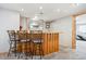 Cozy basement bar featuring wood accents, three barstools, recessed lighting, and a inviting space for entertaining at 29263 Sue Rd, Evergreen, CO 80439