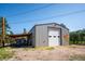 Well-maintained barn/outbuilding with ample storage space and covered area, ideal for various hobbies and projects at 29263 Sue Rd, Evergreen, CO 80439