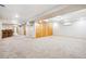 Expansive finished basement area with neutral carpeting and ample storage space at 29263 Sue Rd, Evergreen, CO 80439