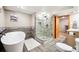 Stylish bathroom featuring soaking tub, frameless glass shower, and contemporary fixtures at 29263 Sue Rd, Evergreen, CO 80439
