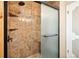 Elegant tiled shower with a glass door, showcasing built-in shelves and modern fixtures at 29263 Sue Rd, Evergreen, CO 80439
