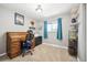 Charming bedroom with a classic roll-top desk, a comfortable chair, and natural light streaming through the window at 29263 Sue Rd, Evergreen, CO 80439
