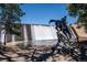 A statue of a person riding a horse in front of a water dam, on a sunny day at 29263 Sue Rd, Evergreen, CO 80439