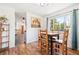 Bright dining area featuring a square table, wood chairs, and a view of the outdoors at 29263 Sue Rd, Evergreen, CO 80439
