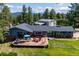 Charming single-story home featuring an expansive deck with outdoor seating, perfect for entertaining and relaxation at 29263 Sue Rd, Evergreen, CO 80439