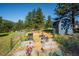 Property includes a garden with raised garden beds, storage shed and fenced yard at 29263 Sue Rd, Evergreen, CO 80439
