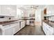 Well-lit kitchen with white cabinets, stainless steel appliances, and stylish countertops at 29263 Sue Rd, Evergreen, CO 80439