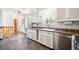 Spacious kitchen with white cabinetry, stainless steel appliances, and cozy breakfast bar at 29263 Sue Rd, Evergreen, CO 80439