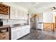 Kitchen with stainless steel refrigerator, white cabinets and tile floors at 29263 Sue Rd, Evergreen, CO 80439