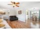 Open-concept living area with wood-look floors flowing into a dining space, filled with light at 29263 Sue Rd, Evergreen, CO 80439
