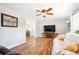 Bright living room with wood-look floors, ceiling fan, modern television and comfortable seating at 29263 Sue Rd, Evergreen, CO 80439