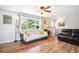 Cozy living room featuring wood-look floors, large window, and comfortable seating area at 29263 Sue Rd, Evergreen, CO 80439