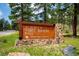 A wooden sign for Alderfer/Three Sisters Park in Jefferson County Open Space, Colorado at 29263 Sue Rd, Evergreen, CO 80439