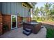 Back patio features a private hot tub and mature trees in backyard at 29263 Sue Rd, Evergreen, CO 80439