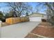 Attached garage with driveway and wooden fence at 11040 Emerson St, Northglenn, CO 80233