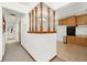 A hallway with a view into the kitchen and a half-wall at 11040 Emerson St, Northglenn, CO 80233