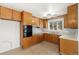 Galley style kitchen with wood cabinets and a built-in oven at 11040 Emerson St, Northglenn, CO 80233