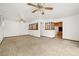 Spacious living room featuring a half wall and ceiling fans at 11040 Emerson St, Northglenn, CO 80233