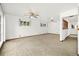 Bright and airy living room with neutral carpeting and ceiling fan at 11040 Emerson St, Northglenn, CO 80233