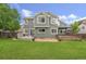 Two-story home featuring a spacious backyard with a wooden deck and a large, well-maintained lawn at 3237 W 113Th Ave, Westminster, CO 80031