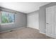Neutral-toned bedroom featuring a window and closet with white paneled doors, carpeted flooring, and gray colored walls at 3237 W 113Th Ave, Westminster, CO 80031