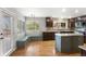 Spacious eat-in kitchen with a light-blue island, hardwood floors, and stainless steel appliances at 3237 W 113Th Ave, Westminster, CO 80031