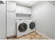 Laundry room with tile flooring, white cabinets, and washer/dryer at 3237 W 113Th Ave, Westminster, CO 80031