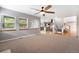 Open living room with a fireplace, windows, carpet floors, and an open view to the kitchen at 3237 W 113Th Ave, Westminster, CO 80031