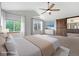 Bright primary bedroom with vaulted ceilings, a barn door leading to the bathroom, and large windows at 3237 W 113Th Ave, Westminster, CO 80031