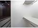 Spacious walk-in closet with dark wood shelving and drawers on one side, and white shelving and rods on the other side at 3237 W 113Th Ave, Westminster, CO 80031
