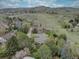 Scenic aerial view of the home with mature trees, mountains and rolling hills in the background at 13959 W Cedar Pl, Golden, CO 80401