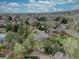 Overhead view showcasing lush landscape, mature trees, and beautiful homes in a desirable neighborhood at 13959 W Cedar Pl, Golden, CO 80401