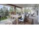 Inviting covered balcony featuring comfortable seating and a dining table with scenic views at 13959 W Cedar Pl, Golden, CO 80401