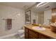 Bathroom featuring a vanity with sink, toilet, and a large mirror, ideal for a simple and functional space at 13959 W Cedar Pl, Golden, CO 80401